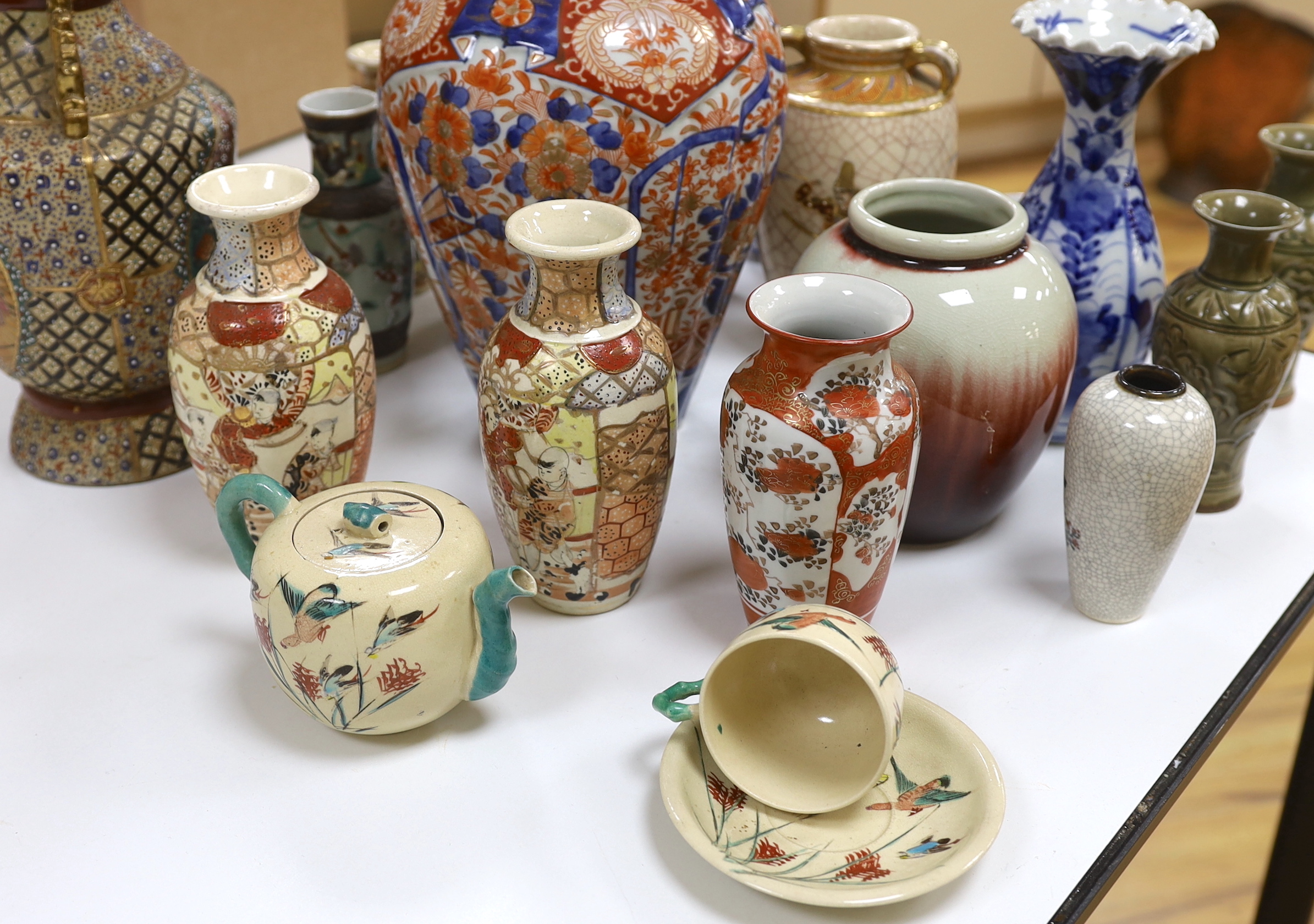 A collection of Japanese ceramics including blue and white vases, an Imari vase and tea bowls, the largest 31cm high